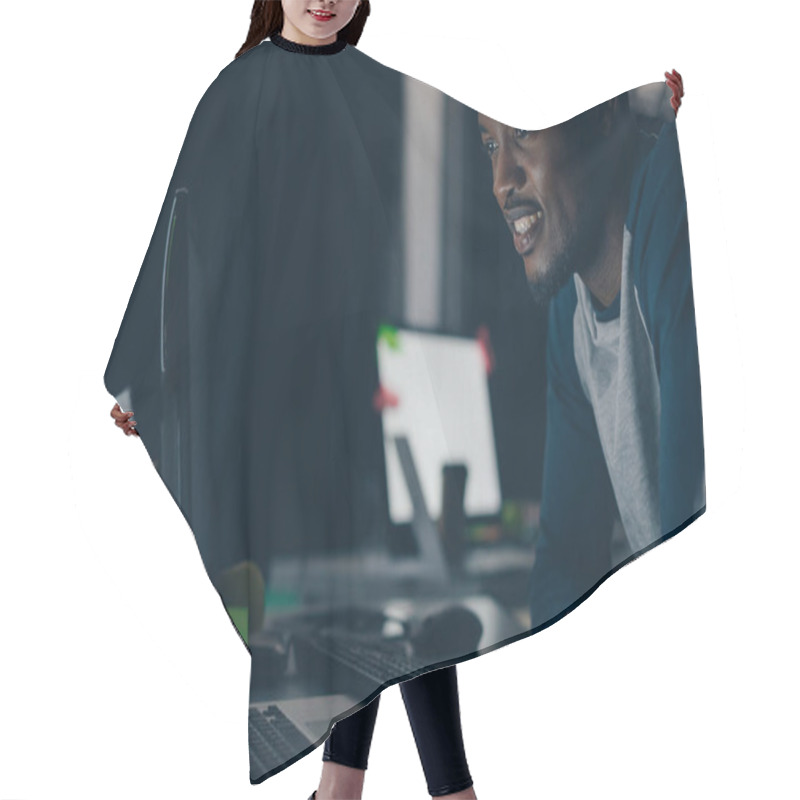 Personality  Young African American Programmer Smiling While Looking At Computer Monitor At Night In Office Hair Cutting Cape