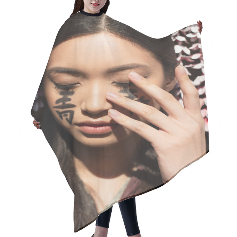 Personality  Japanese Woman With Hieroglyphs Touching Face Isolated On Black  Hair Cutting Cape