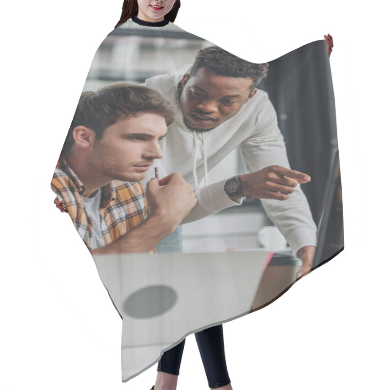 Personality  Serious African American Programmer Pointing At Computer Monitor Near Thoughtful Colleague Hair Cutting Cape