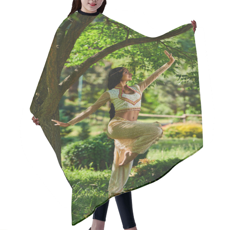 Personality  Young Indian Woman In Traditional Attire Dancing On Green Lawn Under Tree In Summer Park Hair Cutting Cape