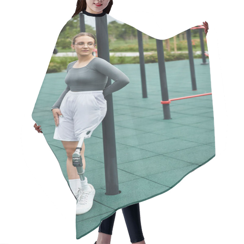 Personality  A Determined Young Woman Balances Gracefully On One Leg While Exercising In A Vibrant Fitness Park. Hair Cutting Cape