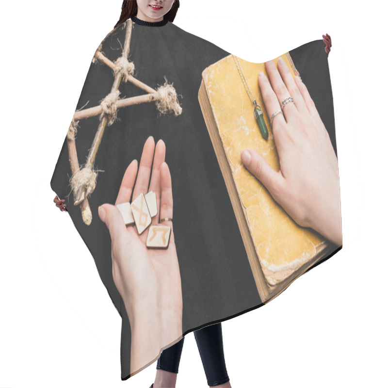 Personality  Top View Of Witch Holding Runes And Putting Hand On Aged Book Near Pentagram On Black Hair Cutting Cape