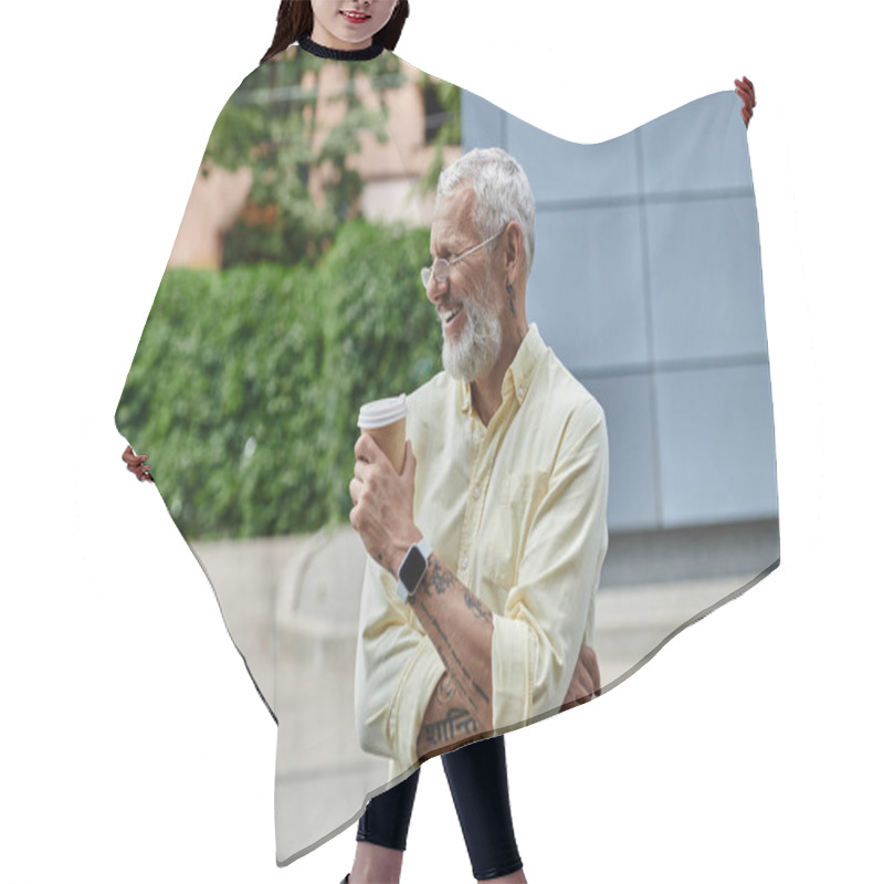 Personality  A Bearded Man In A Yellow Shirt Enjoys A Coffee Break Outside A Modern Building. Hair Cutting Cape