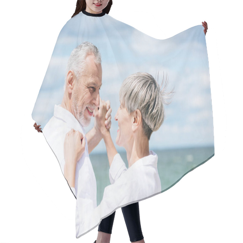 Personality  Happy Senior Couple Looking At Each Other While Dancing At Beach Hair Cutting Cape