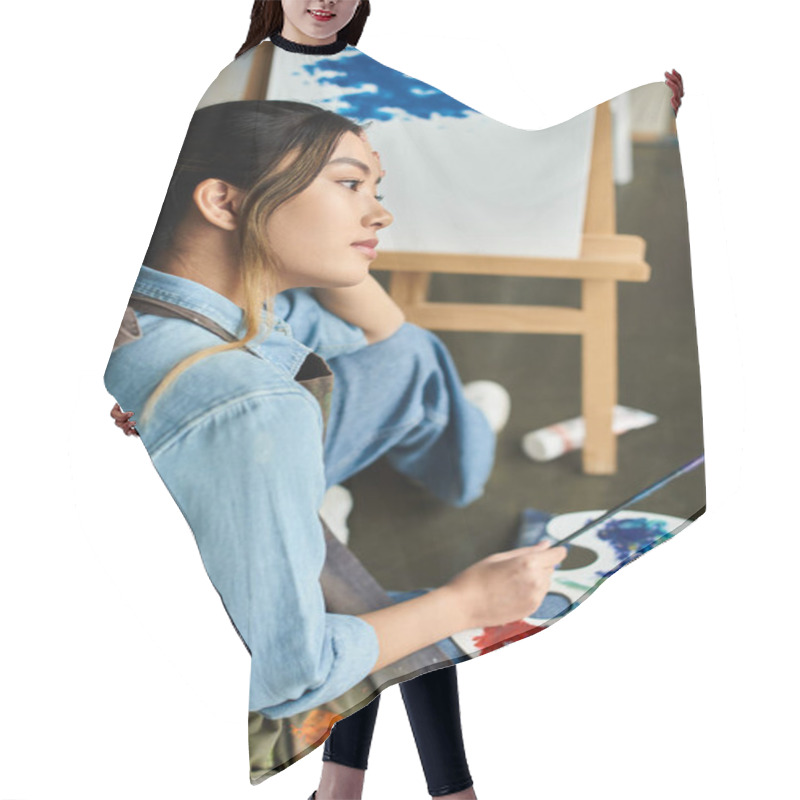 Personality  Woman In Blue Apron Holds Paintbrush In Workshop, Lost In Thought Over Her Painting. Hair Cutting Cape