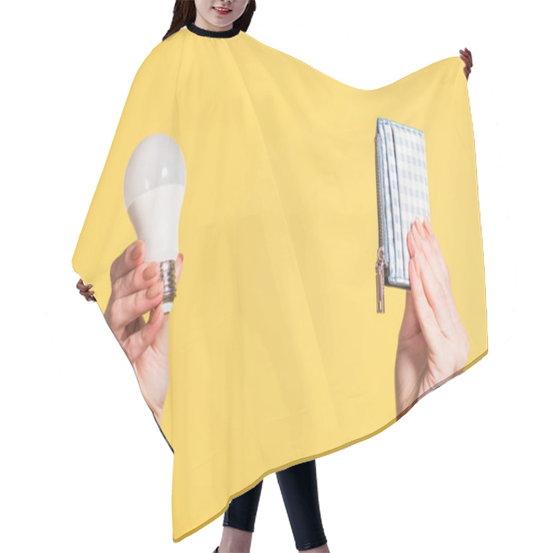 Personality  Cropped View Of Woman Holding Fluorescent Lamp And Wallet In Hands Isolated On Yellow, Energy Efficiency Concept Hair Cutting Cape