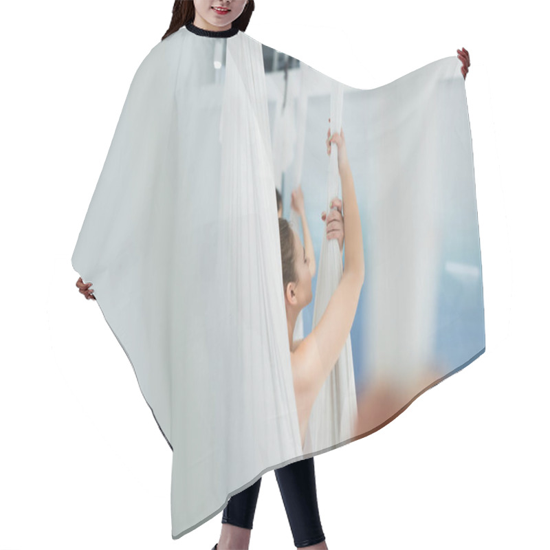 Personality  Selective Focus Of Young Woman Practicing Fly Yoga On Blurred Foreground Hair Cutting Cape