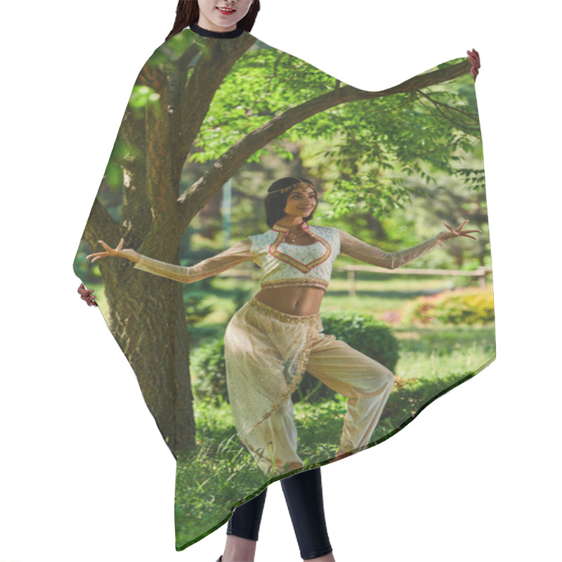 Personality  Graceful Indian Woman In Vibrant Ethnic Attire Dancing Under Tree In Summer Park, Happiness Hair Cutting Cape