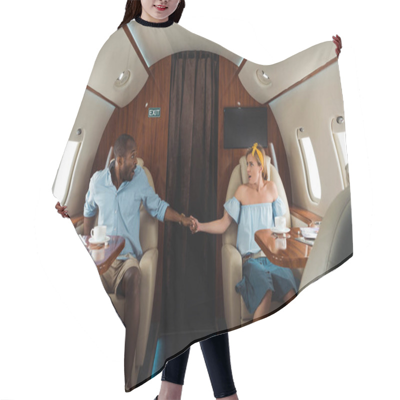 Personality  Scared African American Man And Woman Holding Hands In Private Plane  Hair Cutting Cape