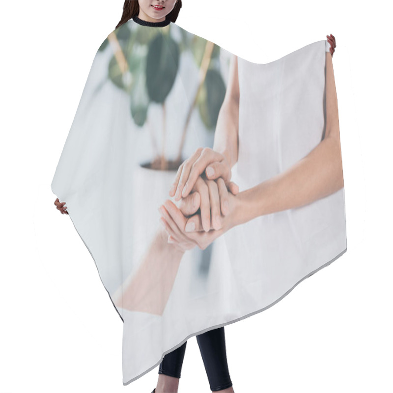 Personality  Cropped Shot Of Reiki Healer Holding Hand Of Male Hand Hair Cutting Cape