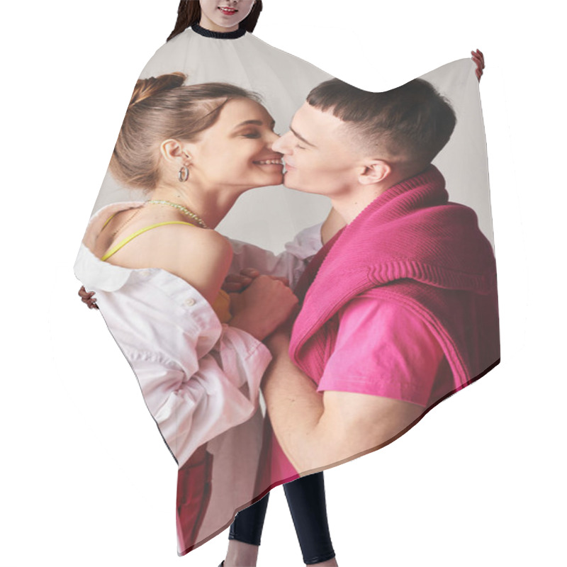 Personality  A Stylish Young Man And Woman Share A Passionate Kiss In A Studio Against A Grey Background. Hair Cutting Cape