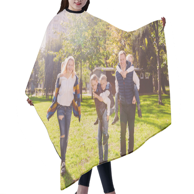 Personality  Theme Family Active Leisure Outside In Nature. Large Caucasian Family With Four Children. Mom And Dad Actively Relaxing. Enjoy Life In Park Near House On Grass. Children On Back Shoulders Roll On Top Hair Cutting Cape