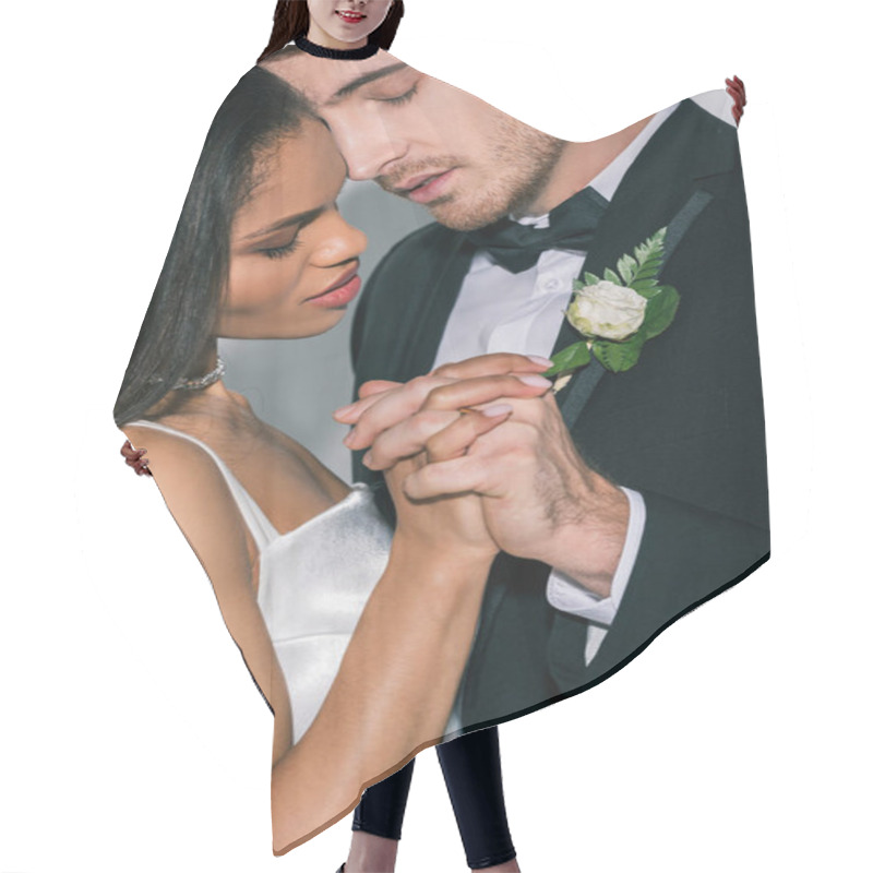 Personality  Young Interracial Newlyweds Holding Hands While Standing Face To Face With Closed Eyes On White Background Hair Cutting Cape