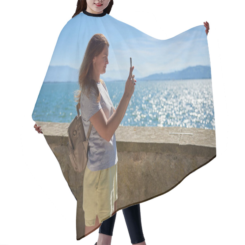 Personality  Woman Capturing Scenic Photos By A Sparkling Lake On A Sunny Day With Majestic Mountain Views. Idyllic Lakeside Setting Showcases Natural Beauty And Outdoor Adventure In A Serene European Landscape Hair Cutting Cape