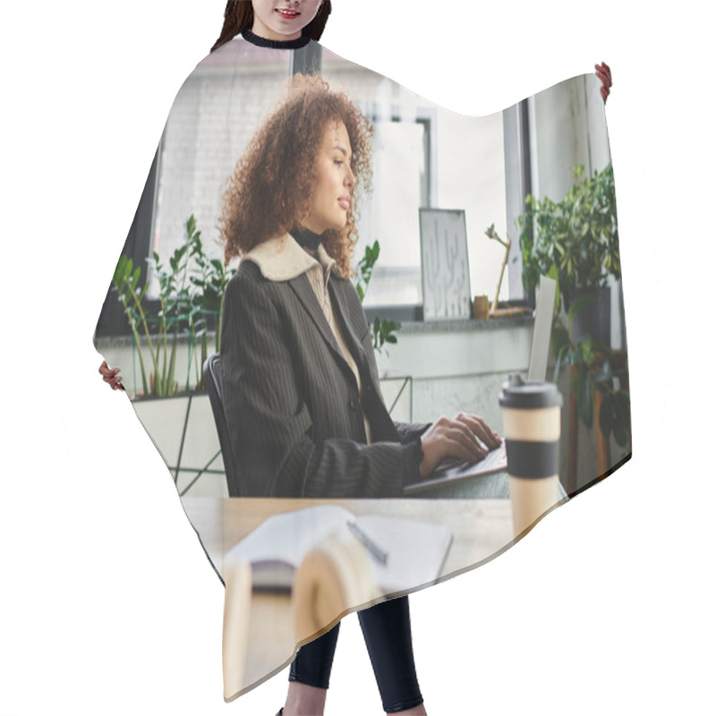 Personality  A Woman With Curly Hair Intently Works On Her Laptop In A Vibrant Office Filled With Greenery. Hair Cutting Cape