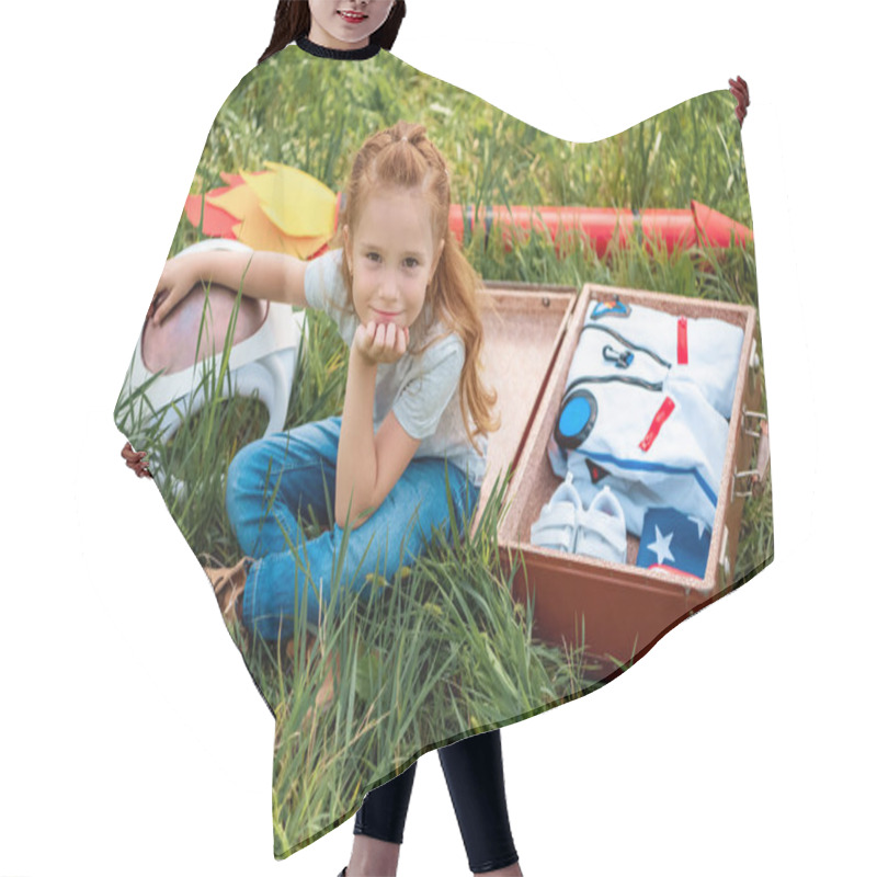 Personality  Smiling Red Hair Kid Sitting Near Suitcase With Cosmonaut Costume And Rocket On Green Grass Hair Cutting Cape