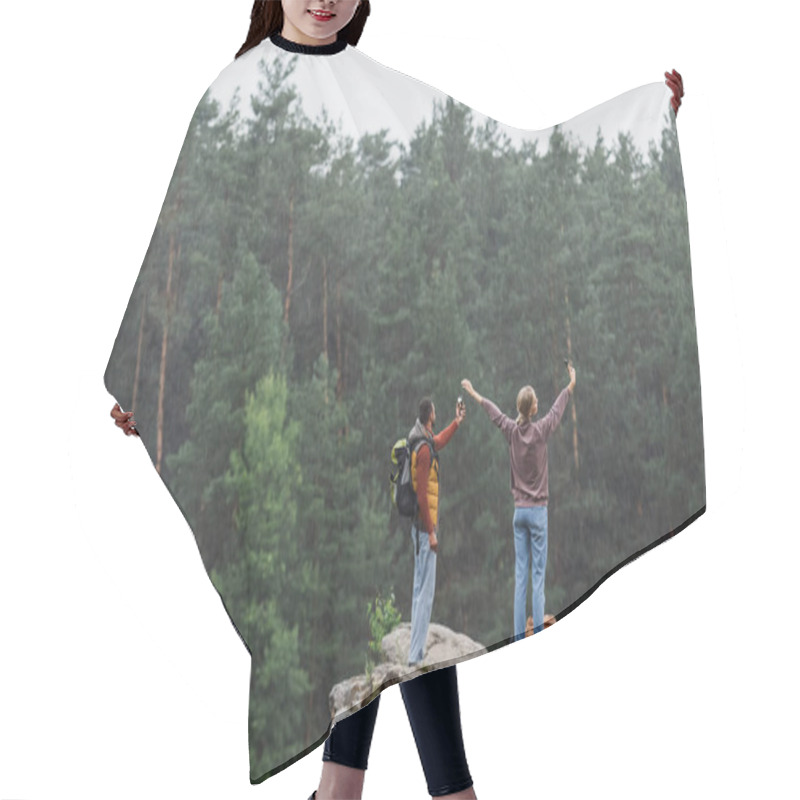 Personality  Back View Of Young Couple With Smartphones Taking Selfie On Rocky Cliff During Rain Hair Cutting Cape