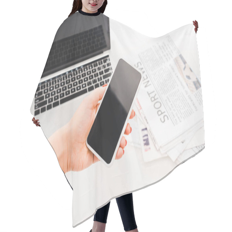 Personality  Selective Focus Of Woman Holding Smartphone With Blank Screen Near Laptop And  Newspapers With Sport News Hair Cutting Cape