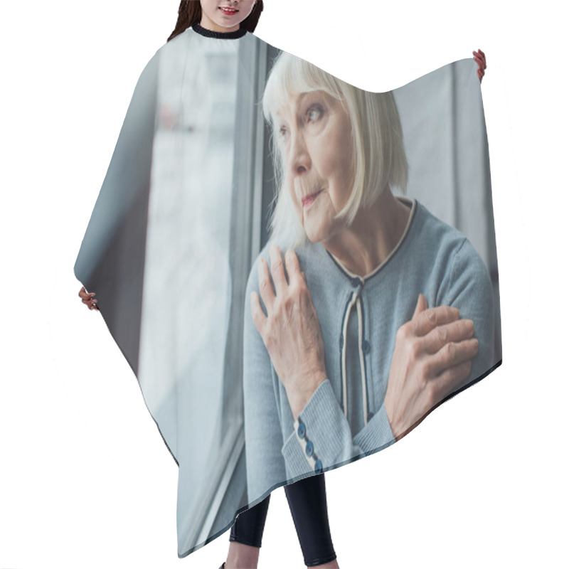 Personality  Pensive Senior Woman With Hands Crossed Looking Through Window At Home  Hair Cutting Cape