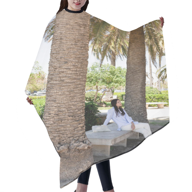 Personality  Full Length View Of Woman Sitting On Bench In Park Under Giant Palms Hair Cutting Cape