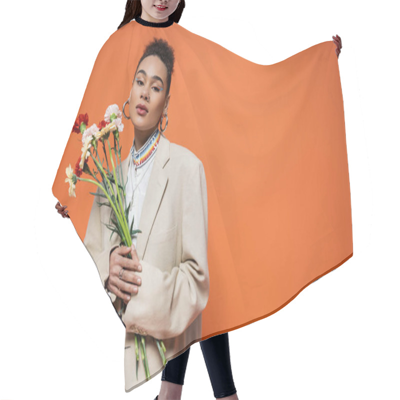 Personality  Beautiful African American Model In Stylish Urban Attire Posing With Flowers, Orange Backdrop Hair Cutting Cape