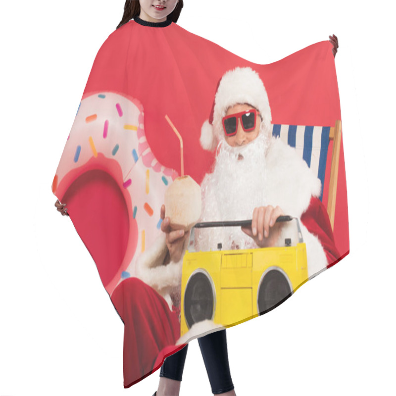 Personality  Santa In Sunglasses Holding Cocktail In Coconut And Boombox On Deck Chair Near Swim Ring On Red Background Hair Cutting Cape