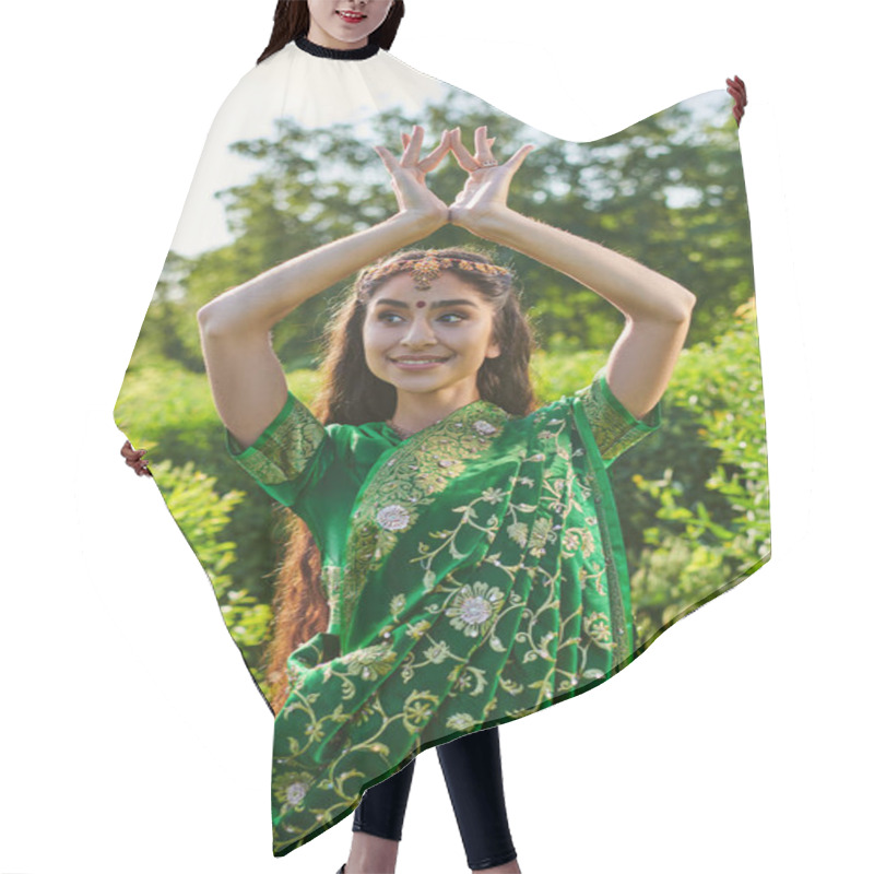 Personality  Cheerful Young Indian Woman In Green Sari And Bindi Gesturing Near Plants In Park Hair Cutting Cape