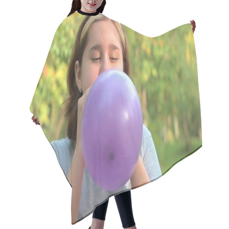 Personality  A Teenage Girl Inflates A Lilac Balloon Close-up Against The Background Of Nature. Hair Cutting Cape