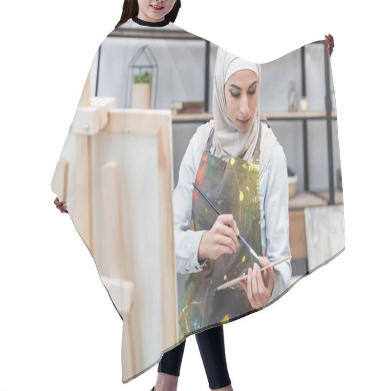 Personality  Young Arabian Woman With Palette And Paintbrush Near Easel In Home Studio Hair Cutting Cape