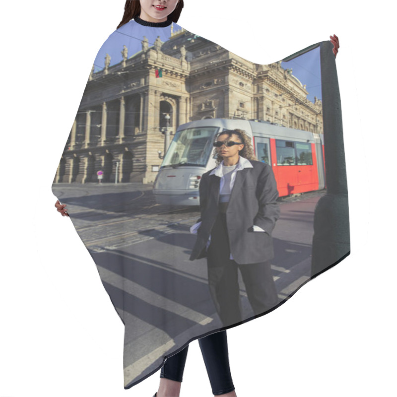 Personality  Stylish African American Woman In Oversized Blazer And Sunglasses Standing With Hands In Pockets Near National Theatre In Prague Hair Cutting Cape