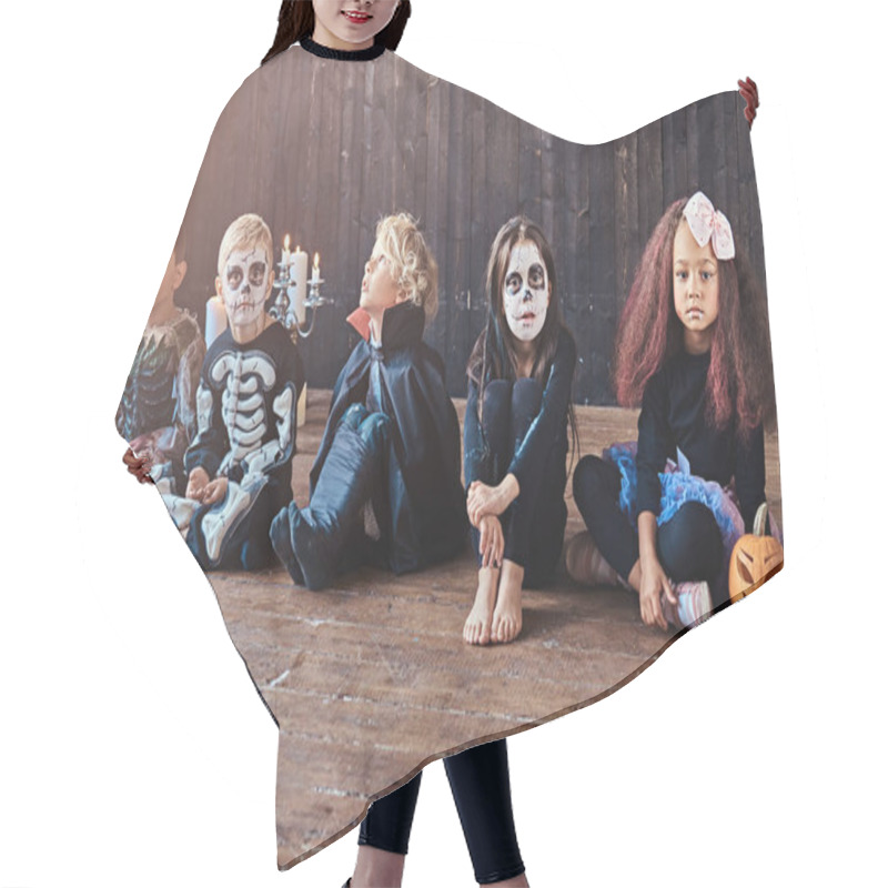 Personality  Halloween Party With Group Children Who Sitting Together On A Wooden Floor In An Old House. Halloween Concept. Hair Cutting Cape