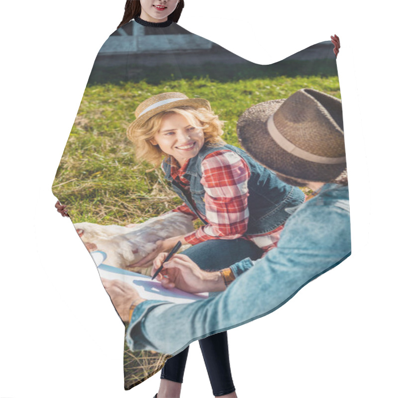 Personality  Cheerful Woman Holding Chicken While Her Boyfriend Making Notes In Clipboard At Farm Hair Cutting Cape