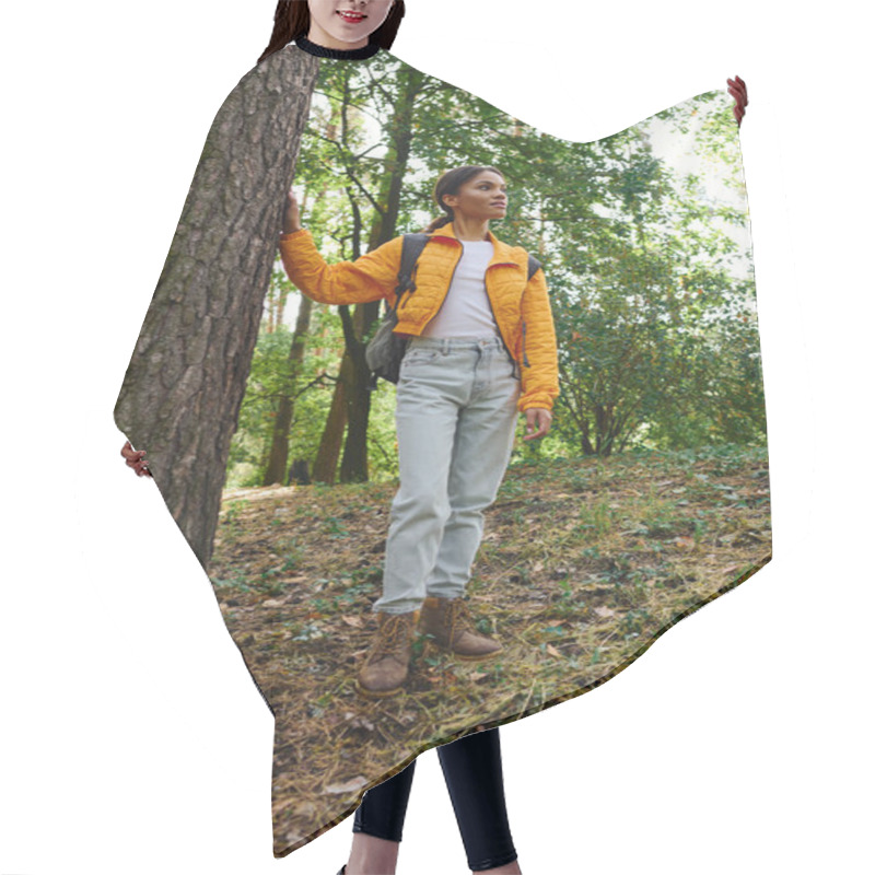 Personality  A Young African American Woman Stands Confidently In An Autumn Forest, Enjoying Her Hiking Adventure. Hair Cutting Cape