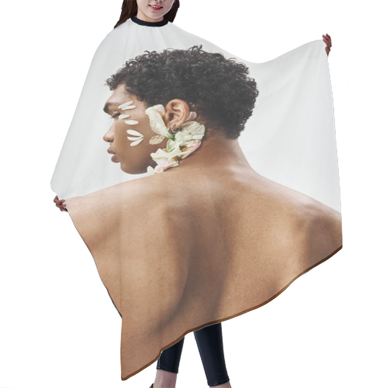 Personality  A Young, Muscular African American Man Poses Against A Grey Background, His Face And Body Decorated With Delicate White Flower Petals. Hair Cutting Cape