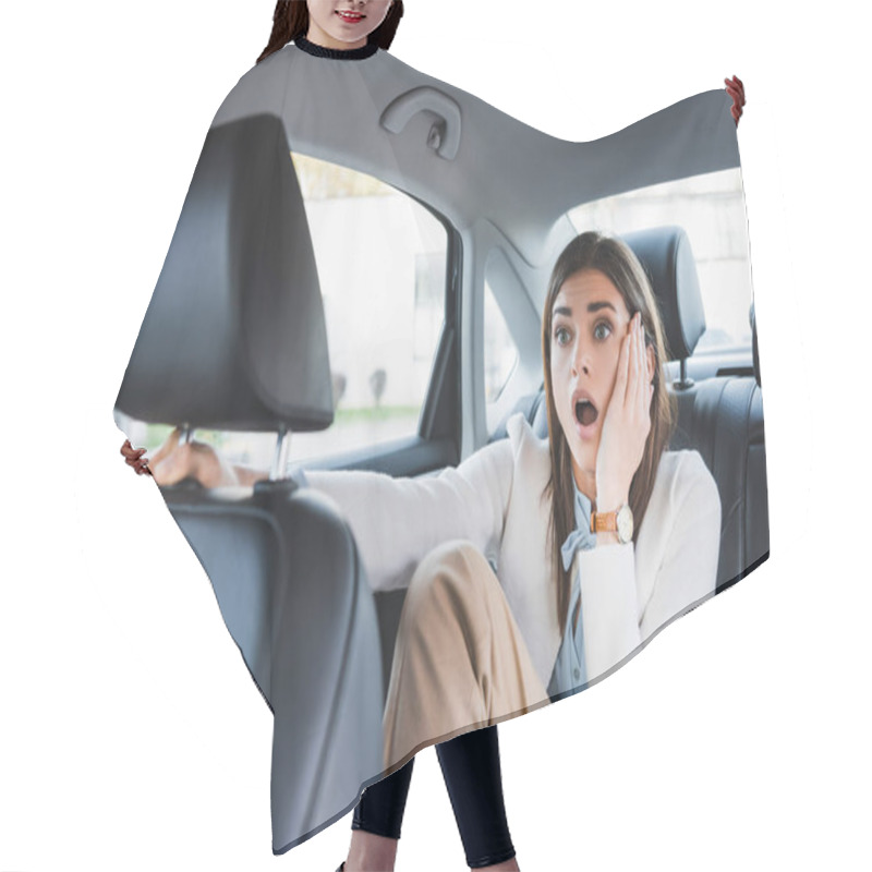 Personality  Scared Woman Holding Hand On Face While Sitting On Back Seat Of Car On Blurred Foreground Hair Cutting Cape