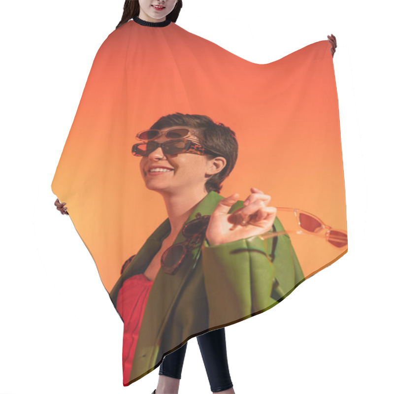 Personality  Young And Carefree Woman Posing In Green Stylish Jacket And Different Trendy Sunglasses On Orange Background Hair Cutting Cape