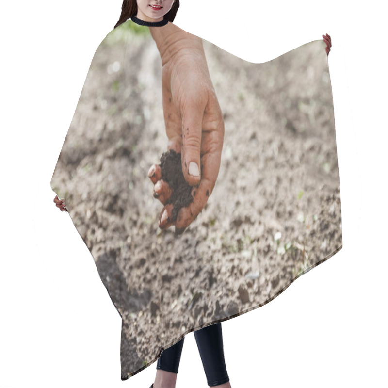 Personality  The Hand Of An Elderly Woman Pours The Earth On Sowing. The Conc Hair Cutting Cape