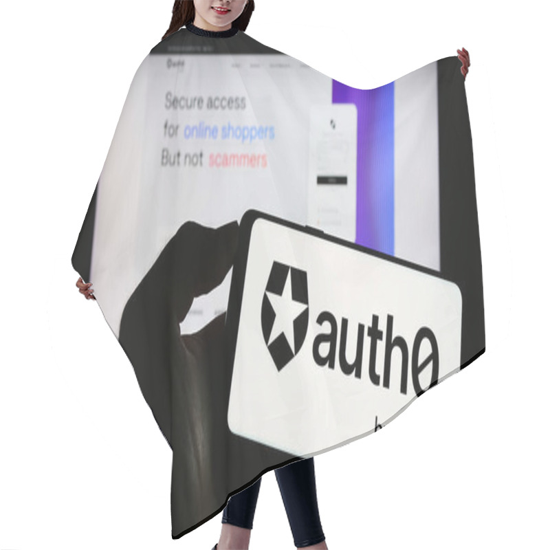 Personality  Stuttgart, Germany - 08-20-2023: Person Holding Mobile Phone With Logo Of American Identity Platform Company Auth0 By Okta On Screen In Front Of Web Page. Focus On Phone Display. Hair Cutting Cape