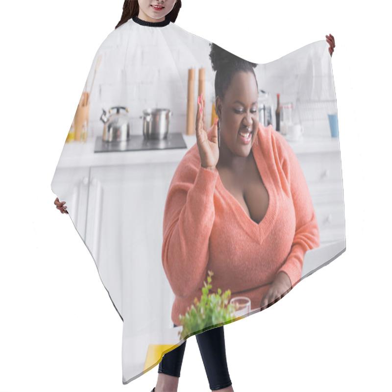 Personality  Happy African American Plus Size Freelancer With Raised Hand Using Laptop At Home Hair Cutting Cape