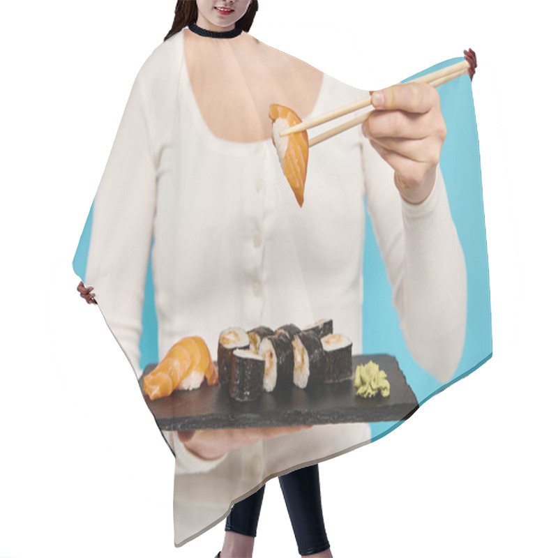 Personality  Cropped View Of Woman Elegantly Holds A Plate Of Sushi And Chopsticks, Savoring Each Bite With A Serene Expression. Hair Cutting Cape