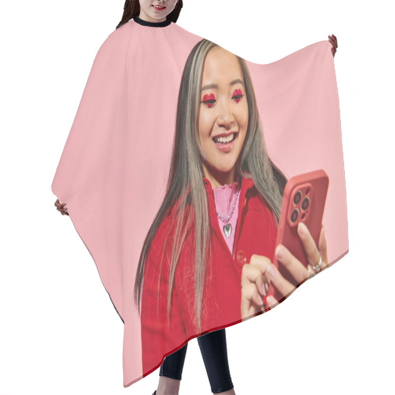 Personality  Cheerful And Young Asian Woman With Red Valentines Day Makeup Using Smartphone On Pink Backdrop Hair Cutting Cape