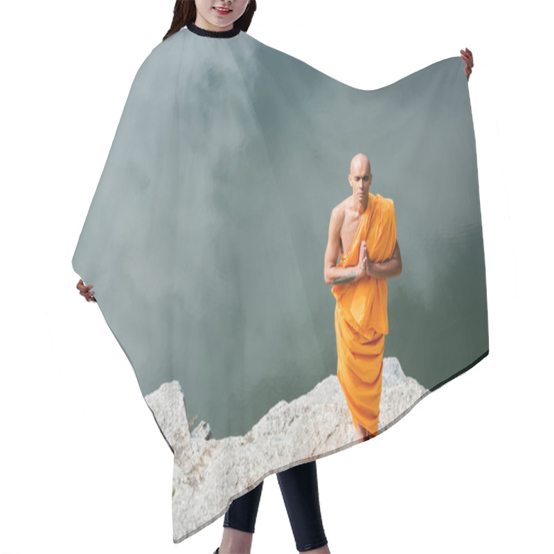 Personality  High Angle View Of Buddhist In Orange Robe Praying On Rocky Cliff Over Water Hair Cutting Cape