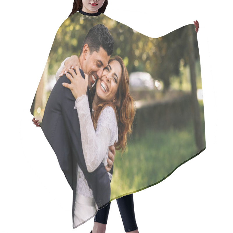 Personality  Bride And Groom Hug Each Other Tightly While Laughing In The Par Hair Cutting Cape