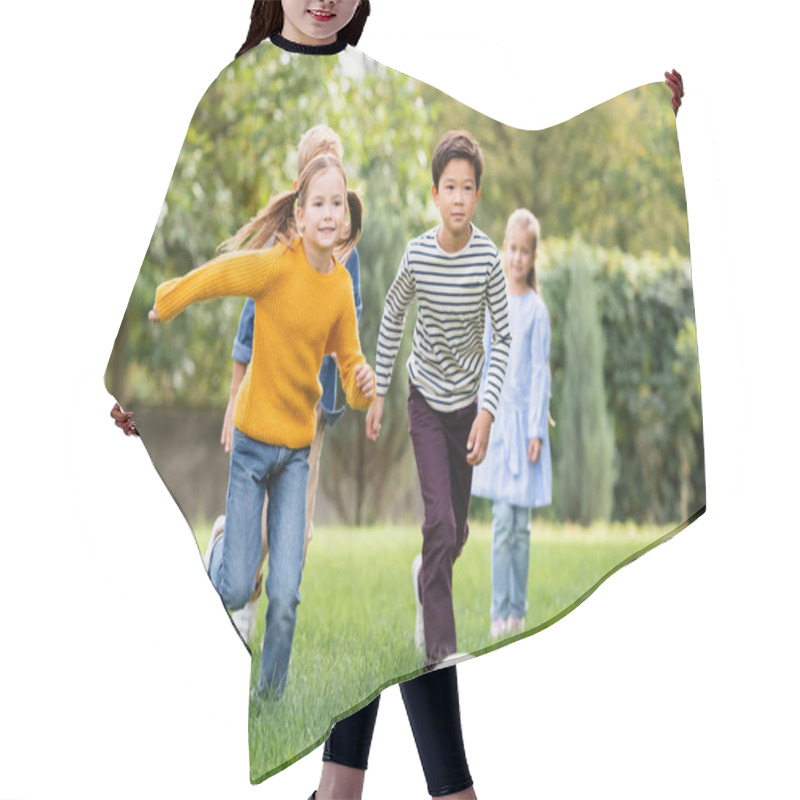 Personality  Cheerful Multiethnic Kids Playing Football Near Friends On Blurred Background In Park  Hair Cutting Cape