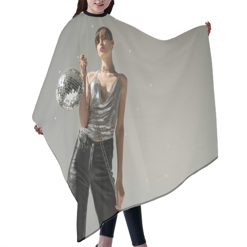 Personality  Stylish Woman In Shiny Top And Leather Pants Holding Disco Ball On Grey Background  Hair Cutting Cape