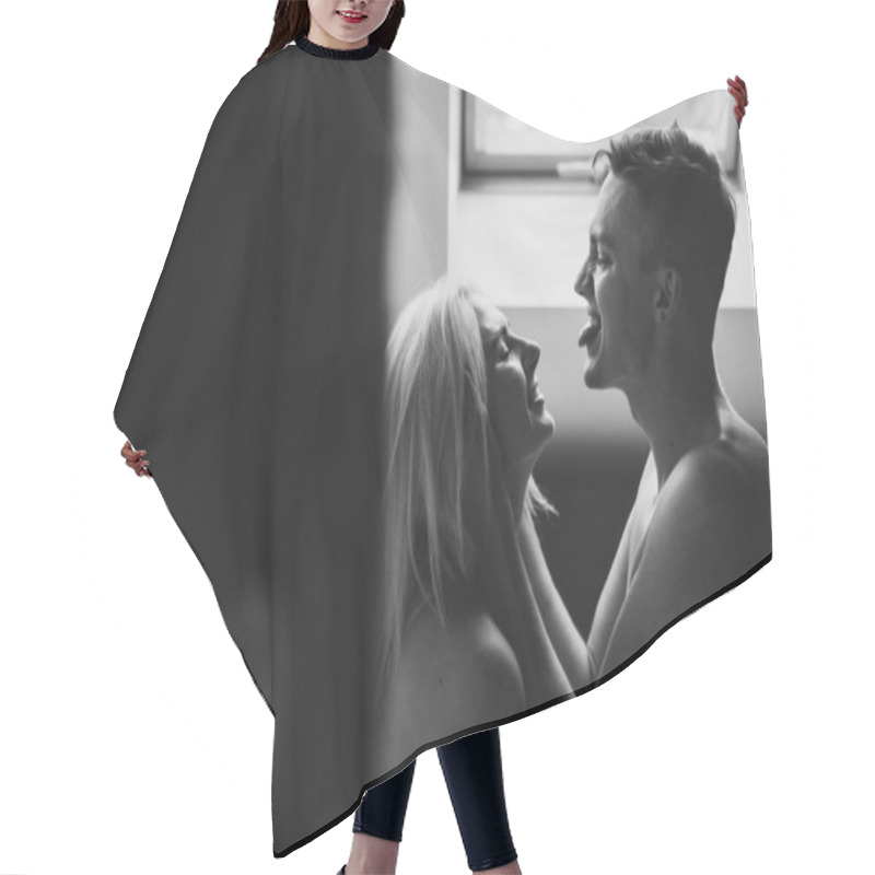 Personality  Young Man And Woman Are Laughing In Bed. Black And White Photo Of A Man And A Woman In Sheets At Home. Hair Cutting Cape