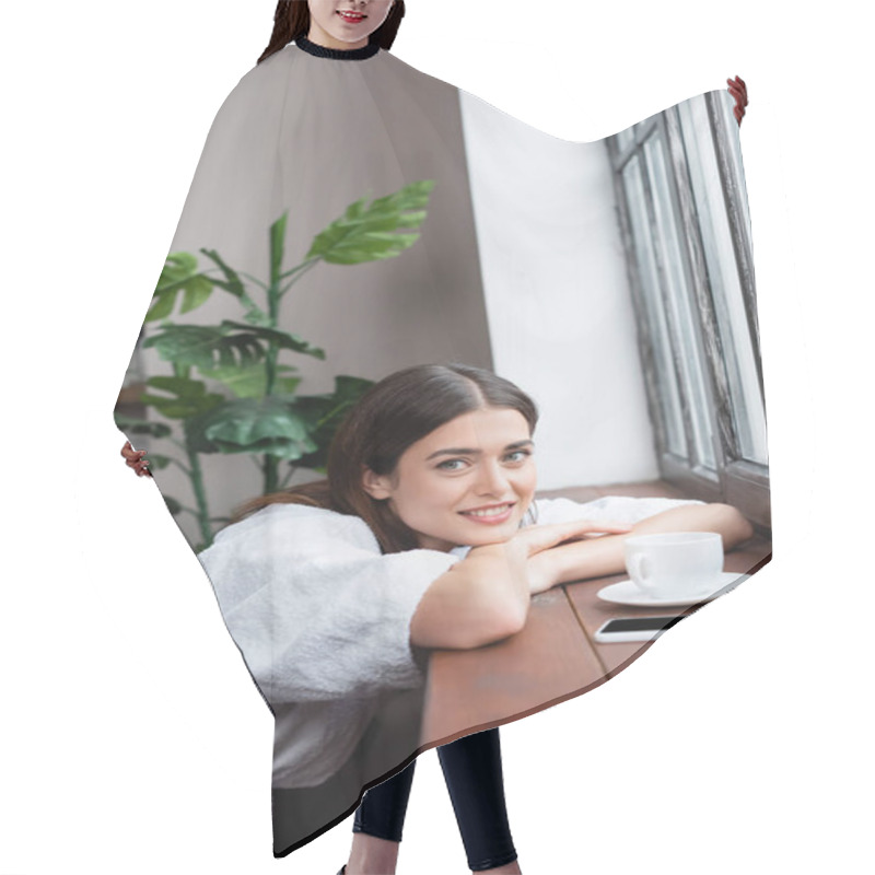 Personality  Dreamy Young Adult Woman Sitting Near Window And Looking At Camera With Head On Hands In Living Room Hair Cutting Cape