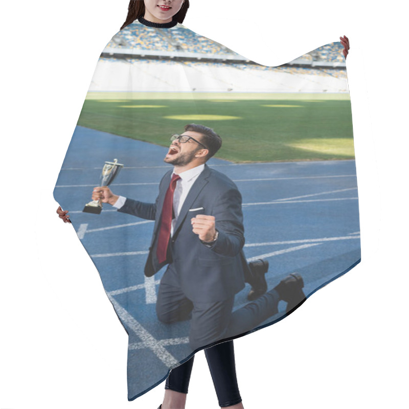 Personality  Young Businessman In Suit Standing On Knees On Running Track With Trophy And Scream At Stadium Hair Cutting Cape