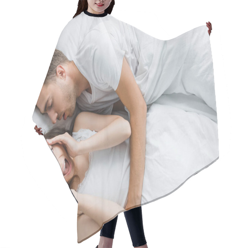 Personality  Top View Of Young Angry Woman Having Headache And Screaming While Lying With Snoring Husband In Bed  Hair Cutting Cape