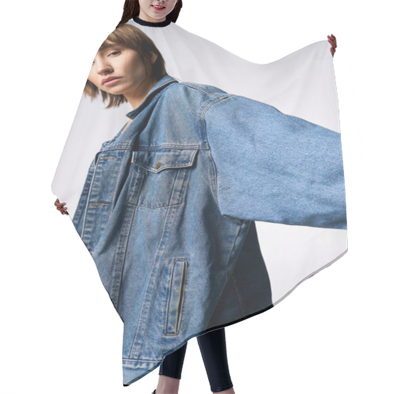 Personality  A Young Woman With Short Hair Is Confidently Posing For A Picture In A Studio, Wearing A Trendy Jean Jacket. Hair Cutting Cape